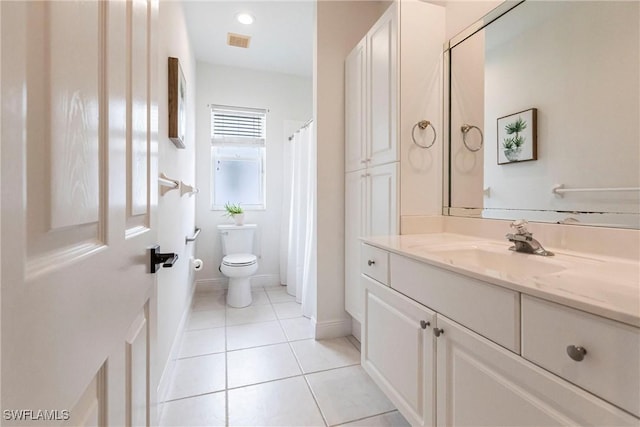 bathroom featuring toilet, tile patterned flooring, and vanity