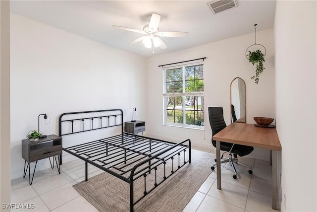 tiled bedroom featuring ceiling fan