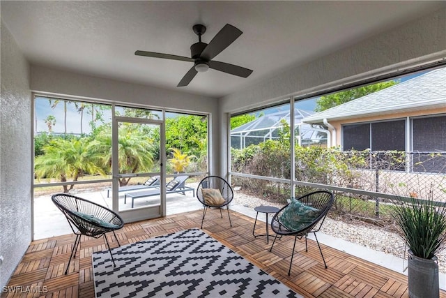 sunroom featuring ceiling fan