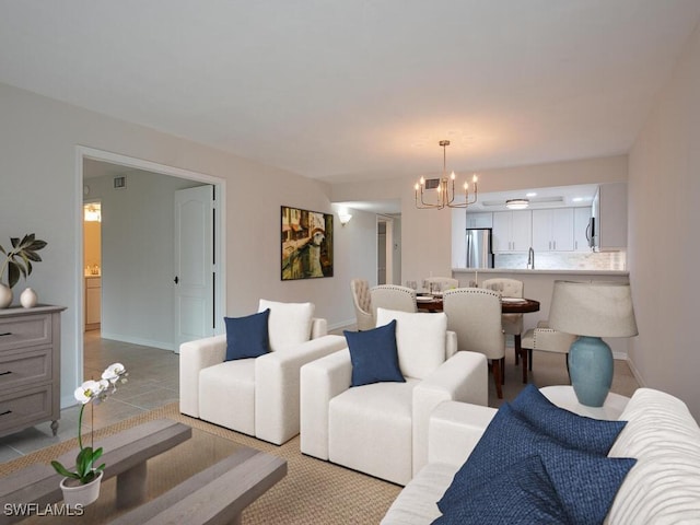 6371 Pelican Bay Blvd Unit N3, Naples, FL 34108 - living room featuring a chandelier, baseboards, and light tile patterned floors