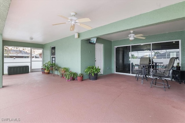 view of patio / terrace with radiator heating unit and ceiling fan