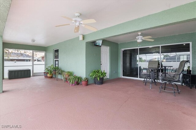 view of patio / terrace featuring ceiling fan and radiator heating unit