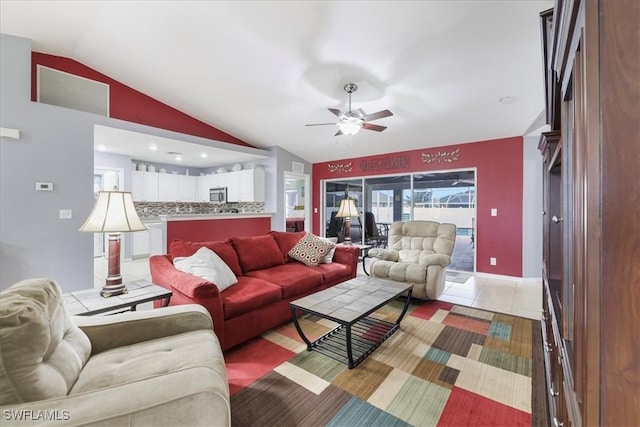 living room with tile patterned flooring, vaulted ceiling, and ceiling fan