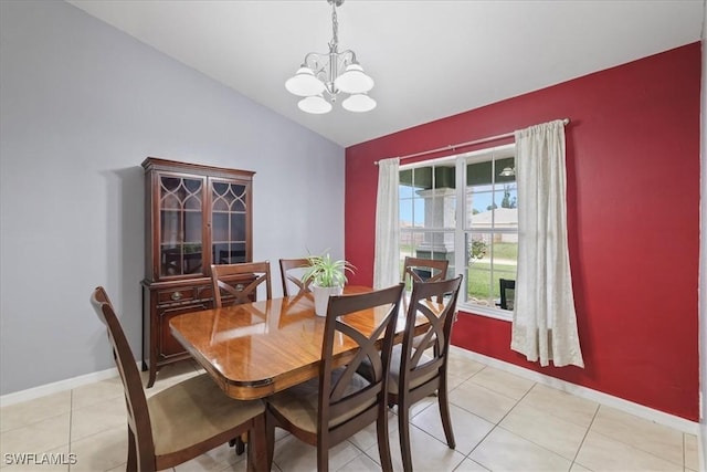 tiled dining space featuring vaulted ceiling and a notable chandelier