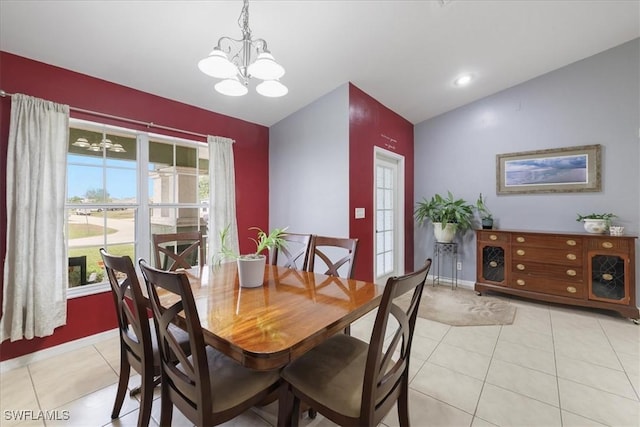 dining room featuring vaulted ceiling, a chandelier, and light tile patterned flooring