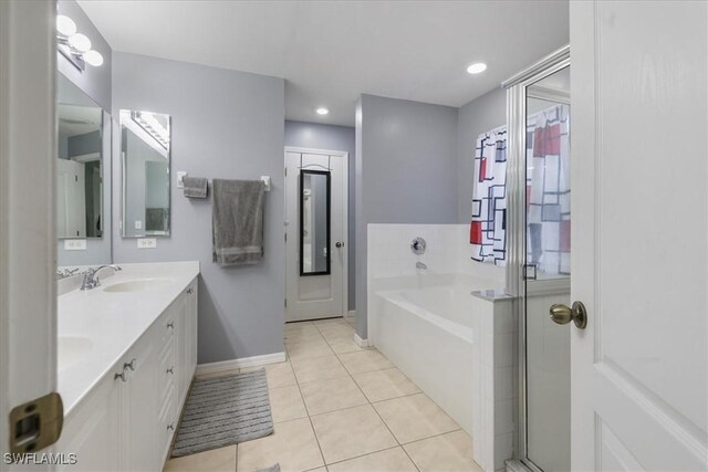 bathroom with tile patterned flooring, vanity, and separate shower and tub