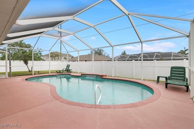 view of swimming pool featuring a patio and glass enclosure