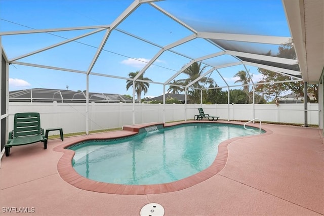 view of pool with glass enclosure and a patio area