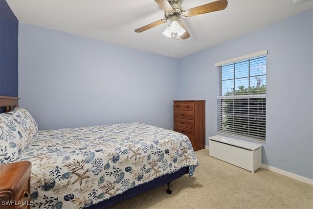 bedroom featuring ceiling fan and light carpet