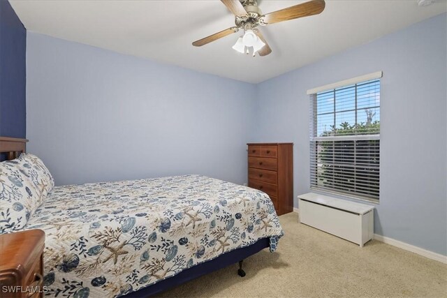 bedroom featuring light colored carpet and ceiling fan