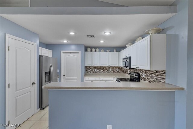 kitchen with white cabinetry, light tile patterned floors, kitchen peninsula, stainless steel appliances, and decorative backsplash