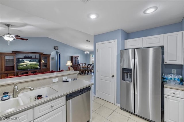 kitchen featuring vaulted ceiling, appliances with stainless steel finishes, white cabinets, light tile patterned floors, and ceiling fan