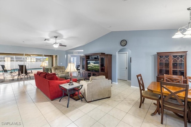 living room featuring vaulted ceiling, ceiling fan with notable chandelier, and light tile patterned flooring