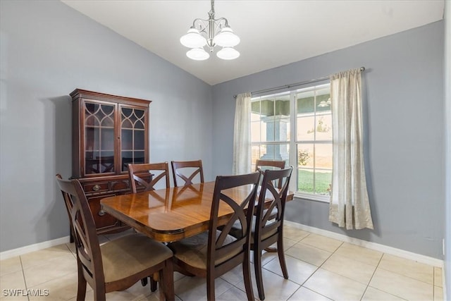 dining room with a notable chandelier, vaulted ceiling, and light tile patterned flooring