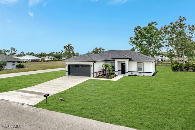 view of front of property featuring a garage and a front yard