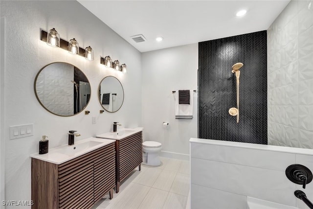 bathroom featuring vanity, toilet, and walk in shower