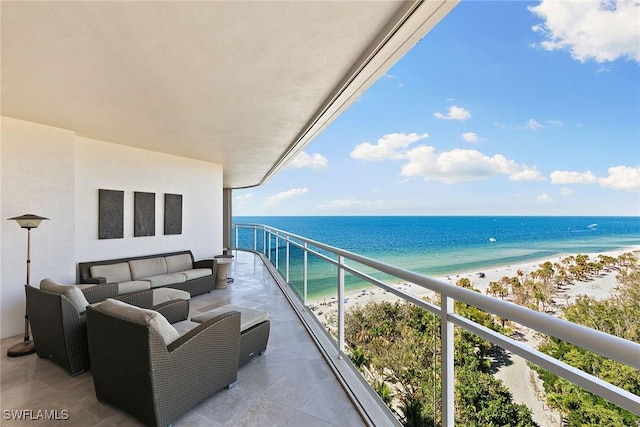 balcony with a water view, a beach view, and an outdoor living space