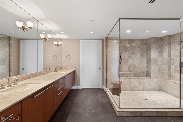 bathroom featuring tile patterned flooring, vanity, and a tile shower