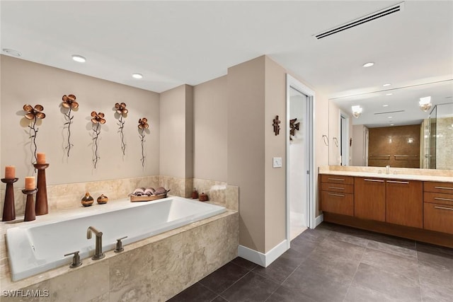 bathroom featuring tile patterned floors, vanity, and plus walk in shower