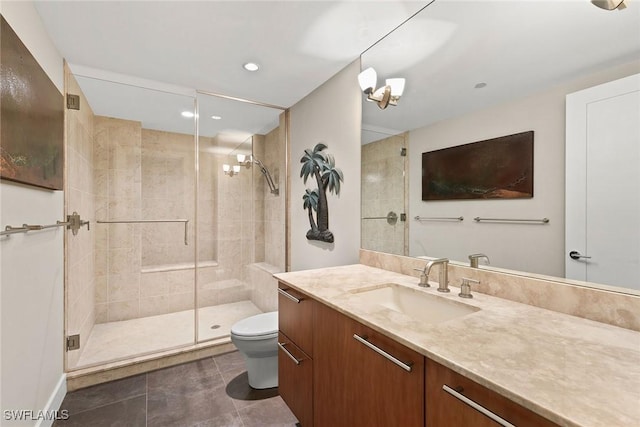 bathroom featuring vanity, a shower with shower door, and toilet