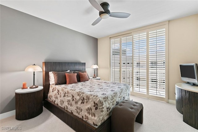 bedroom featuring access to exterior, light colored carpet, and ceiling fan