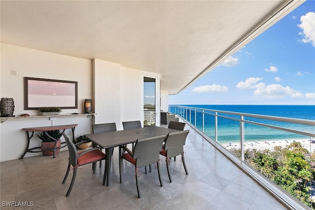 balcony with a water view and a beach view