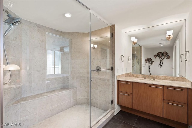 bathroom featuring vanity, tile patterned floors, and a shower with shower door