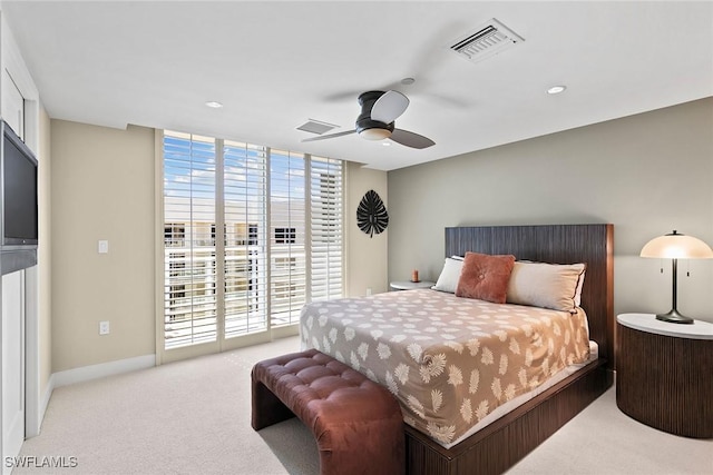 carpeted bedroom with ceiling fan, floor to ceiling windows, access to exterior, and multiple windows