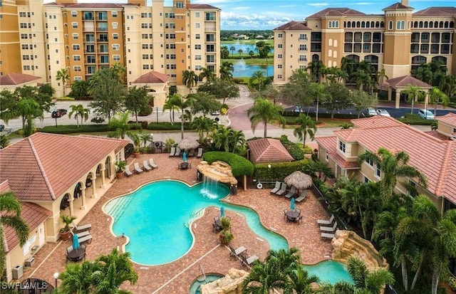 view of swimming pool with pool water feature and a patio