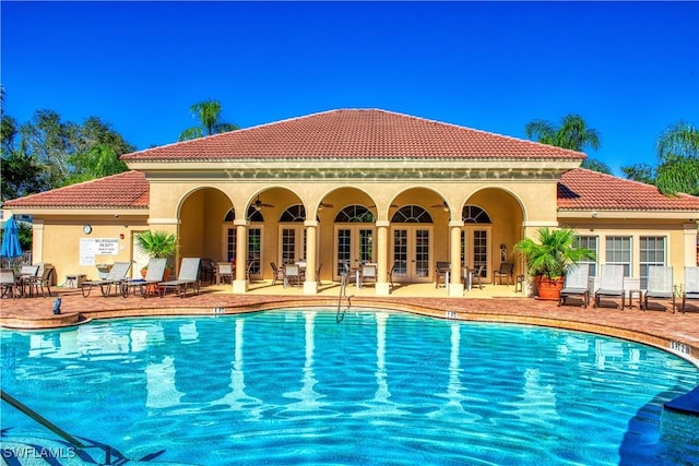 view of pool with french doors and a patio area