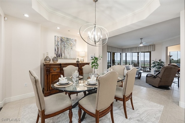 dining space featuring light tile patterned floors, ornamental molding, and a raised ceiling