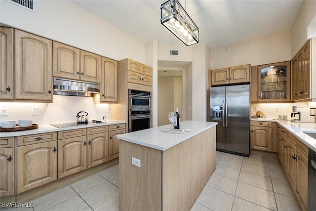 kitchen featuring a kitchen island, pendant lighting, light tile patterned floors, and black appliances