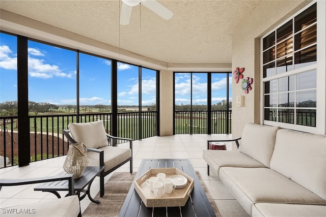 sunroom with a wealth of natural light and ceiling fan