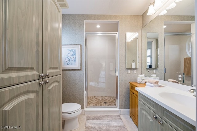 bathroom with vanity, tile patterned floors, toilet, and walk in shower