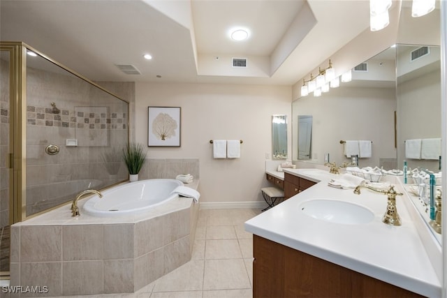 bathroom featuring tile patterned flooring, vanity, separate shower and tub, and a tray ceiling