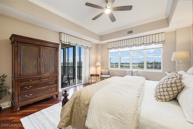 bedroom with ornamental molding, access to outside, dark hardwood / wood-style flooring, and a tray ceiling