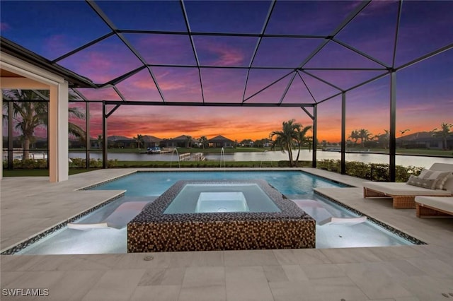 pool at dusk featuring an in ground hot tub, a water view, a patio, and glass enclosure