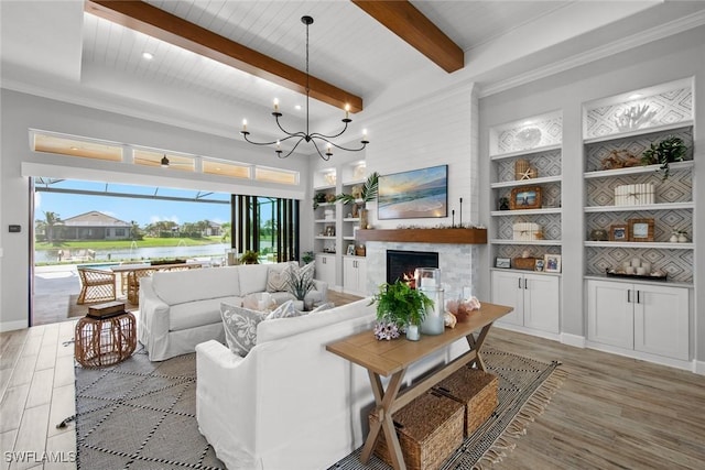 living room with a notable chandelier, beam ceiling, light hardwood / wood-style flooring, and built in features