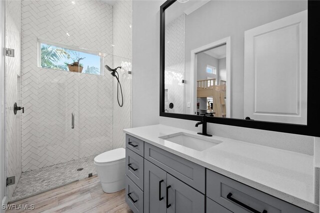 bathroom with vanity, an enclosed shower, wood-type flooring, and toilet