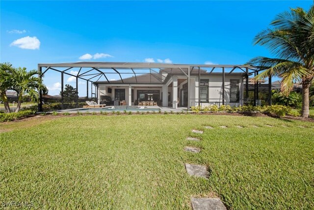 back of house featuring a yard and a lanai