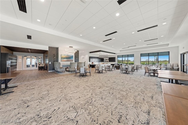 carpeted living room featuring a tray ceiling