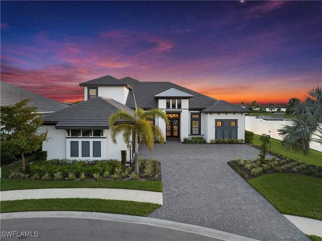 view of front facade featuring a water view and french doors