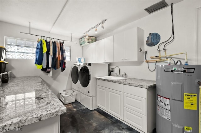 laundry area with cabinets, sink, electric water heater, and washing machine and clothes dryer