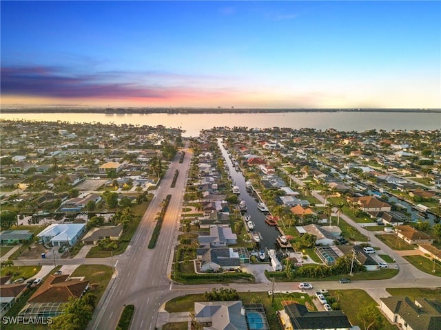 aerial view at dusk with a water view