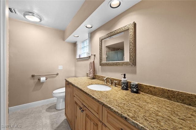 bathroom featuring vanity, tile patterned floors, and toilet