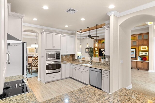 kitchen featuring sink, white cabinetry, crown molding, and appliances with stainless steel finishes