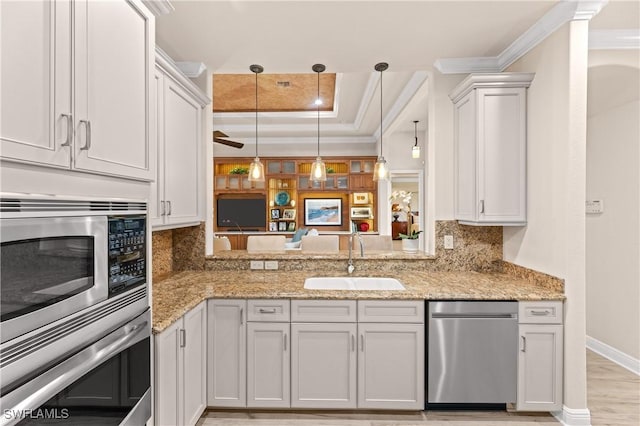 kitchen with sink, white cabinetry, stainless steel appliances, and tasteful backsplash