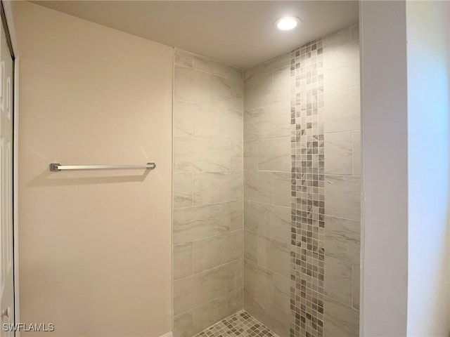 bathroom with tiled shower