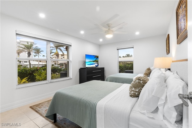 tiled bedroom featuring ceiling fan