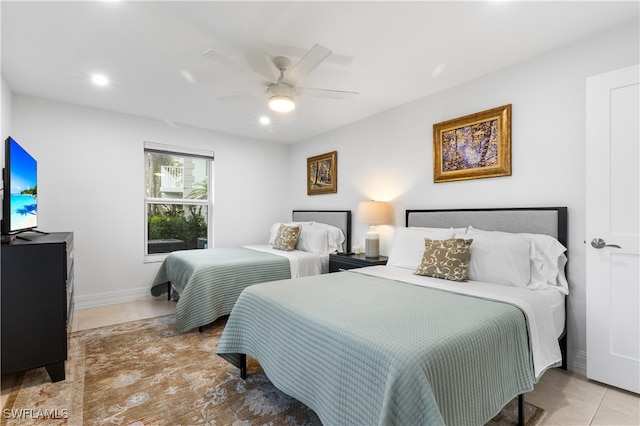 bedroom with ceiling fan and light tile patterned floors